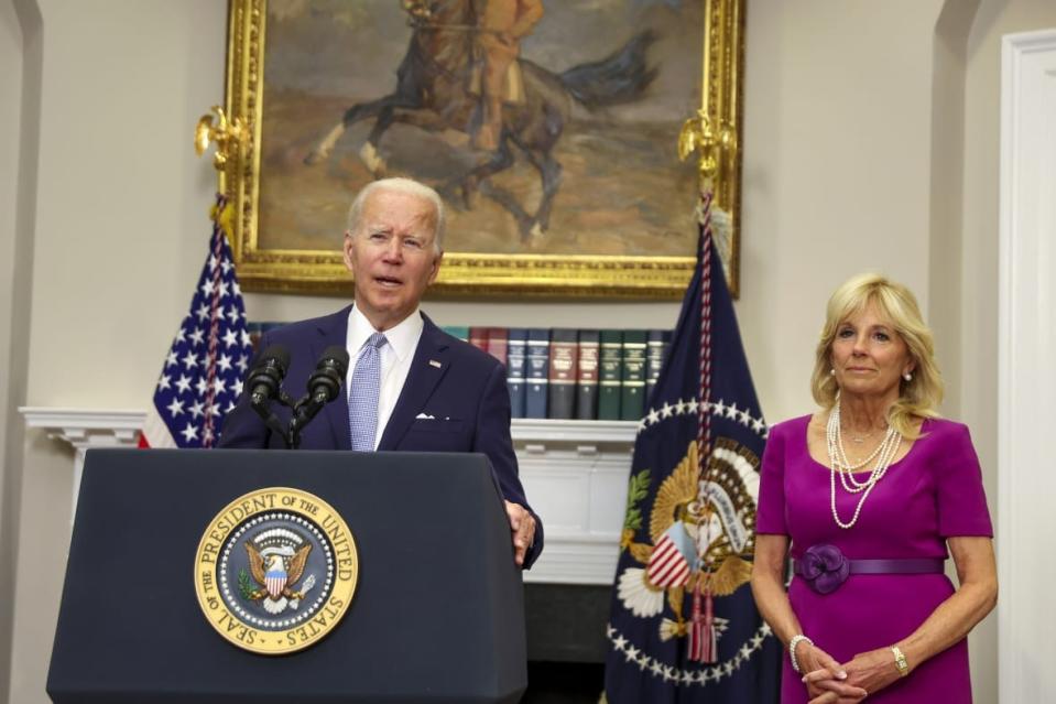 U.S. President Joe Biden speaks as first lady Jill Biden looks on before signing the Bipartisan Safer Communities Act into law in the Roosevelt Room of the White House on June 25, 2022 in Washington, DC. (Photo by Tasos Katopodis/Getty Images)