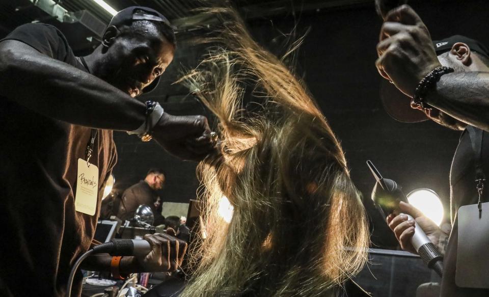 Stylist prepare models for the runway show unveiling the latest fashion creation from Brandon Maxwell, during New York Fashion Week, Saturday, Sept. 7, 2019, in the Brooklyn borough of New York. (AP Photo/Bebeto Matthews)