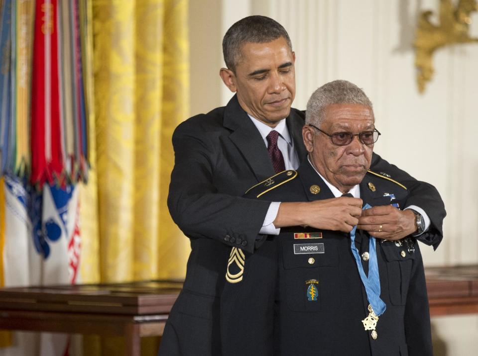 President Barack Obama awards Army Staff Sgt. Melvin Morris the Medal of Honor during a ceremony in the East Room of the White House in Washington, Tuesday, March 18, 2014. President Obama awarded the Medals of Honor to 24 ethnic or minority U.S. soldiers who performed acts of bravery under fire in three of the nation’s wars, that were denied because of prejudice. (AP Photo/Manuel Balce Ceneta)