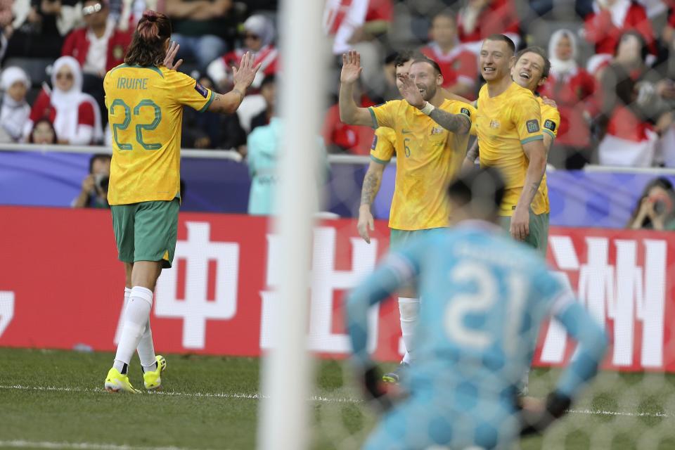 Australia's Graig Goodwin, 1st right, celebrates with his teammates after scoring the third goal during the Asian Cup round of 16 soccer match between Australia and Indonesia at Jassim Bin Hamad Stadium in Doha, Qatar, Sunday, Jan. 28, 2024. (AP Photo/Hussein Sayed)