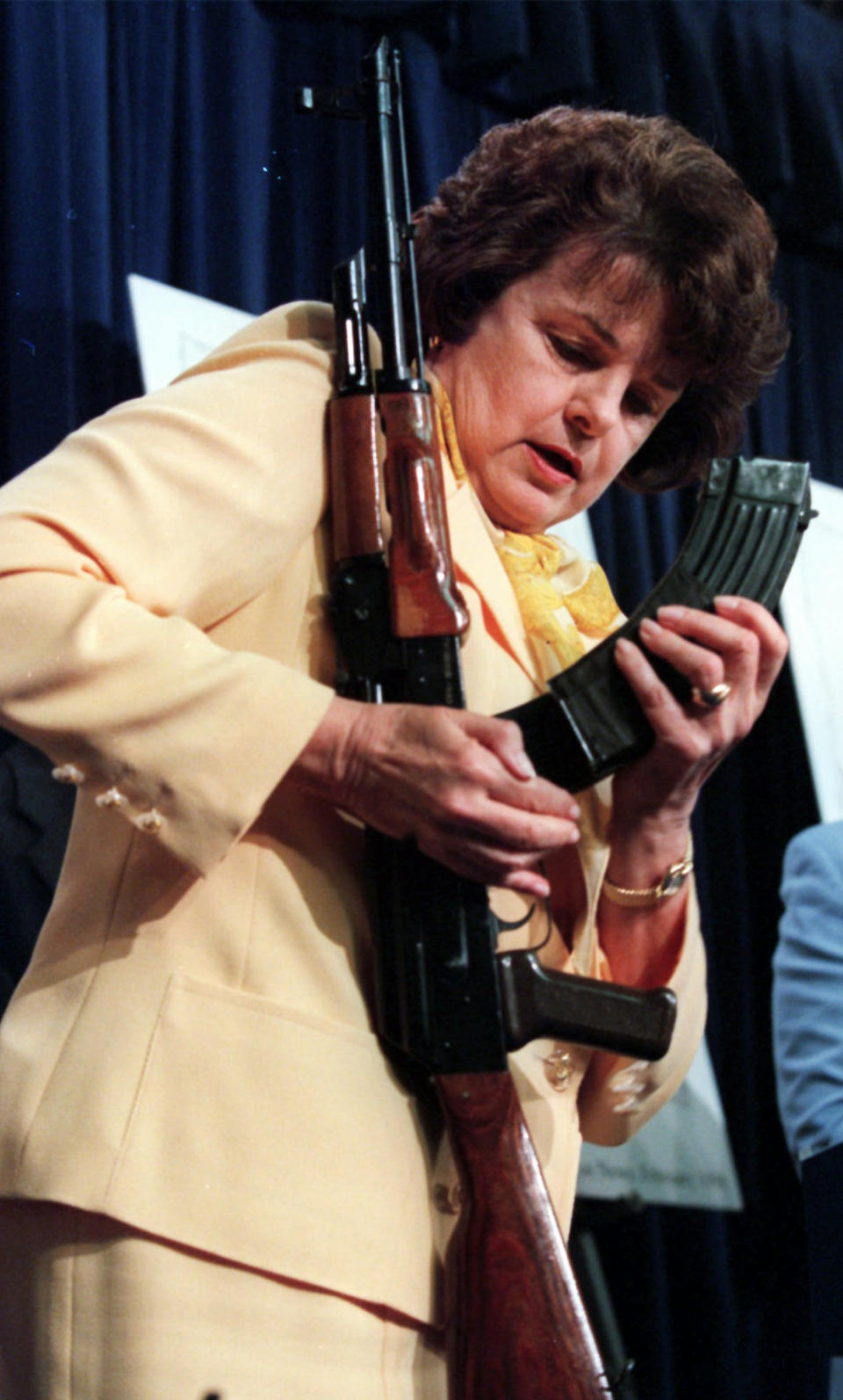 FILE - U.S. Sen. Dianne Feinstein, D-Calif., examines a magazine from an AK-47 during a Capitol Hill news conference, March 31, 1998. (AP Photo/Khue Bui, File)