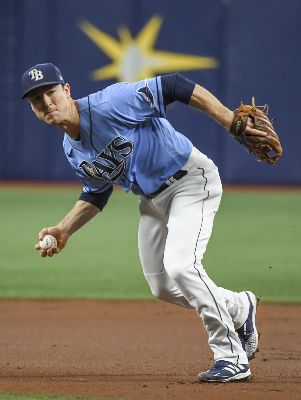 Tampa Bay Rays infielder Joey Wendle barehands an infield single hit by Toronto Blue Jays' Teoscar Hernandez during the first inning of a baseball game Friday, July 9, 2021, in St. Petersburg, Fla.(AP Photo/Steve Nesius)