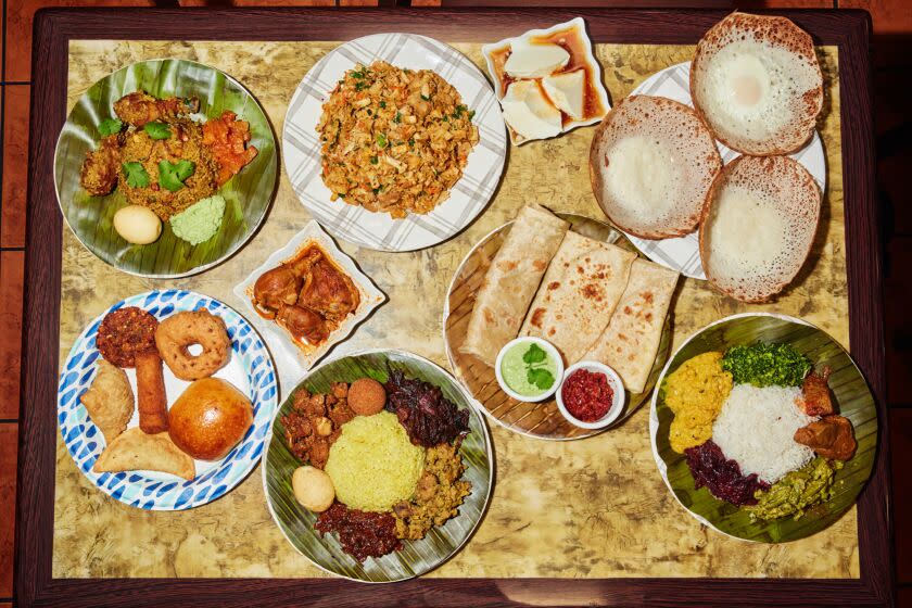 NORTHRIDGE, CA - DECEMBER 3, 2022: Sri Lankan dishes from Baja Sub. Clockwise from top right: Plain and Egg Hoppers, Fish Curry Plate, Plain and Egg Roti, Lamprais, Sri Lankan Snacks, Chicken Curry, Chicken Biriyani, Kottu Roti, and Kiri Pani. (Oscar Mendoza / For The Times)