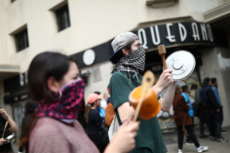 Demonstrators hit pots during a protest against the increase in the subway ticket prices in Santiago