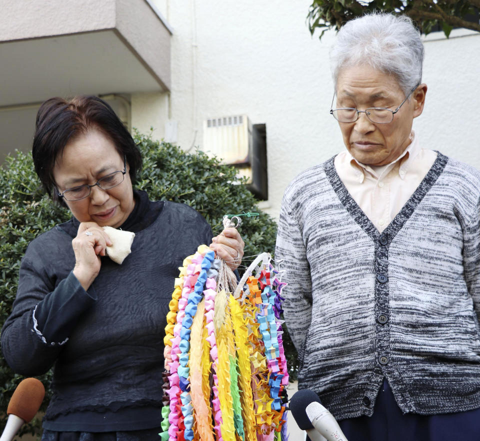 Mother Sachiko Yasuda cries while speaking to the media with father Hideaki Yasuda of Japanese freelance journalist Jumpei Yasuda outside their home in Iruma, northwest of Tokyo, Wednesday, Oct. 24, 2018. A man believed to be journalist Yasuda who disappeared three years ago in Syria has been released and is now in Turkey, a Japanese official said. (Kyodo News via AP)