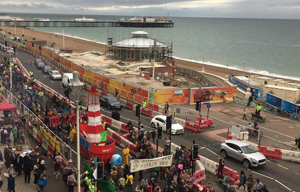 Extinction Rebellion protesters - accompanied by a boat - have blocked a street in Brighton as they demonstrate outside the Labour Party conference.