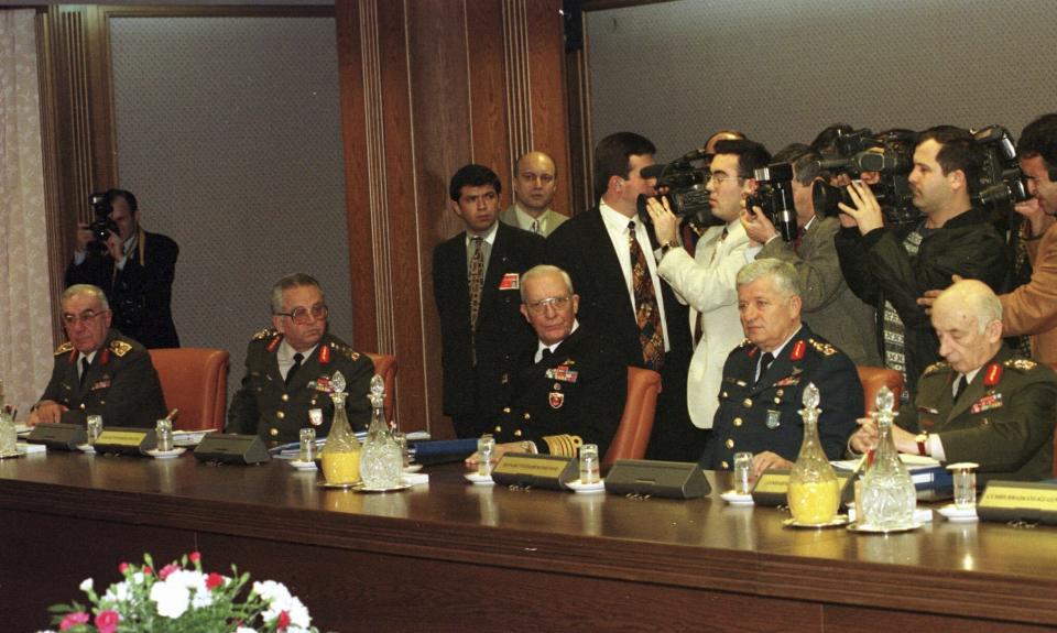 FILE - Turkish Chief of Staff Gen. Ismail Hakki Karadayi, and other top commanders, from left, Hikmet Koksal, Guven Erkaya, Ahmet Corekci and Teoman Koman, who formed the military wing of the nation's most influental body, National Security Council, during a crucial meeting on Friday, Feb. 28,1997. Turkish President Recep Tayyip Erdogan on Friday, May 17, 2024, pardoned seven former top military officers who were sentenced to life terms in prison over the ouster of an Islamic-led government in 1997. Those pardoned and expected to be released from prison later on Friday include Cetin Dogan, 83, who was head of military operation at the time. Former Gen. Cevik Bir, 85, who was deputy chief of military staff, was released along with other officers earlier due to ill-health. The main defendant, former Chief of General Staff İsmail Hakkı Karadayı, died in 2020, while the appeals process was still continuing. Teoman Koman was one of the generals involved with the 1997 ''post-modern coup''. He died in 2013. (AP Photo/Burhan Ozbilici, File)