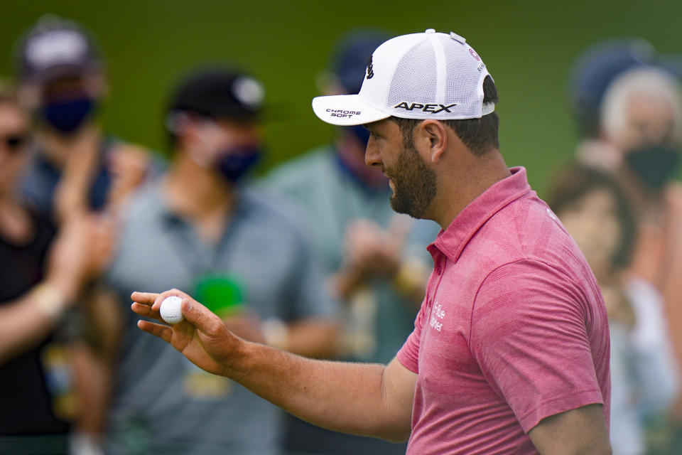Jon Rahm, of Spain, holds up his ball after an eagle on the second hole during the final round of the Masters golf tournament on Sunday, April 11, 2021, in Augusta, Ga. (AP Photo/Matt Slocum)