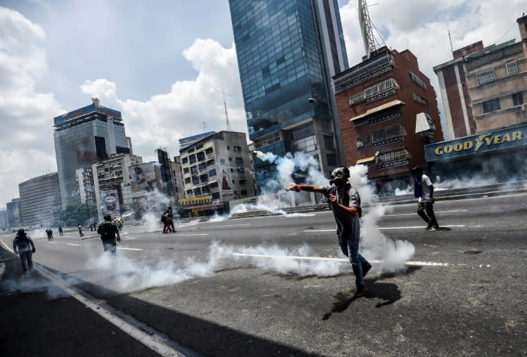 Demonstrators clash with the police during a rally against Venezuelan President Nicolas Maduro, in Caracas on April 19, 2017
