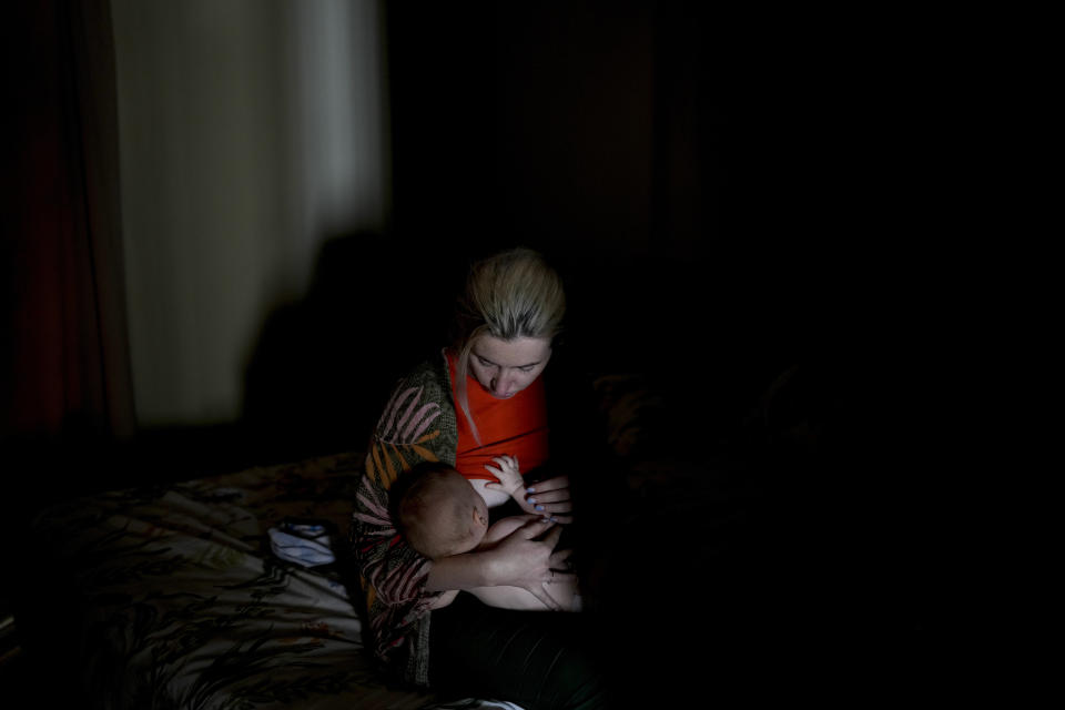 Russian national Alla Prigolovkina breastfeeds her Argentine-born son Lev Andres, at their home in Mendoza, Argentina, Tuesday, Feb. 14, 2023. All children born in Argentina automatically receive citizenship and having an Argentine child speeds up the process for the parents to obtain residency permits and, after a couple of years, their own passports. (AP Photo/Natacha Pisarenko)