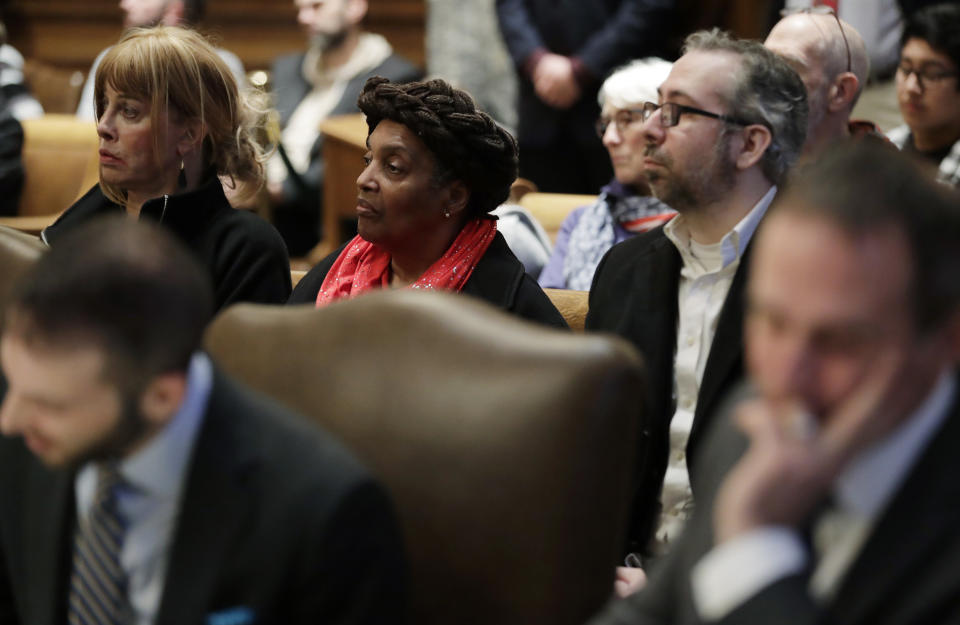 Washington state presidential electors Esther John, center, and Bret Chiafalo, right, sit behind their attorneys Tuesday, Jan. 22, 2019, during a Washington Supreme Court hearing in Olympia, Wash., on a lawsuit addressing the constitutional freedom of electors to vote for any candidate for president, not just the nominee of their party. (AP Photo/Ted S. Warren)