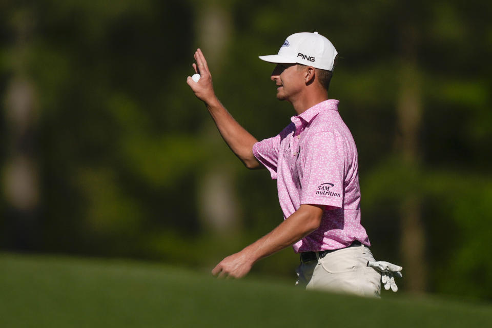 Sam Bennett waves on the 12th hole during the final round of the Masters golf tournament at Augusta National Golf Club on Sunday, April 9, 2023, in Augusta, Ga. (AP Photo/Matt Slocum)