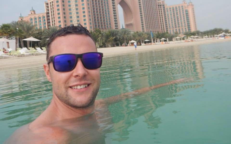 Jamie Harron in front of Atlantis The Palm Hotel, Dubai - SWNS.com