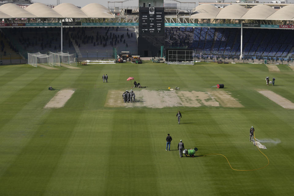 Ground staff give final touches of arrangements at the National Stadium for upcoming Pakistan Super League, in Karachi, Pakistan, Saturday, Feb. 11, 2023. Karachi will host the first leg of nine matches of Pakistan Super League Twenty20 cricket tournament, beginning from Monday. (AP Photo/Fareed Khan)