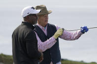 Darius Rucker, left, and Bill Murray read the fourth green of the Pebble Beach Golf Links during the third round of the AT&T Pebble Beach Pro-Am golf tournament in Pebble Beach, Calif., Saturday, Feb. 5, 2022. (AP Photo/Eric Risberg)