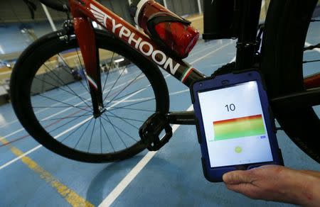 Johan Kucaba, Equipment Coordinator at UCI holds a tablet using magnetic resonance technology to detect a bike equipped with a motor during a media event at the Union Cycliste Internationale (UCI) in Aigle, Switzerland May 3, 2016. REUTERS/Denis Balibouse