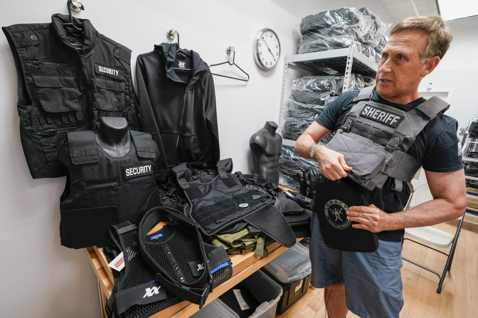 Brad Pedell, a founder of 221B Tactical, demonstrates how a Level 3 plate and plate carrier are used during an interview with The Associated Press, Tuesday, June 14, 2022, at the company's headquarter in New York. (AP Photo/Mary Altaffer)