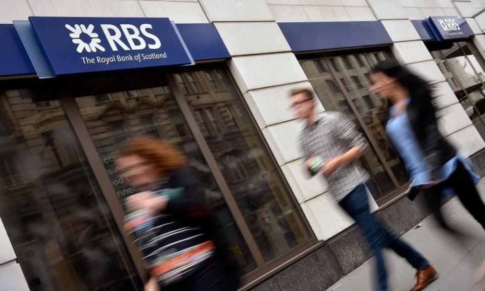 People walk past an RBS branch in London