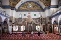 In this Tuesday, Sept. 24, 2019 photo, Israeli Arabs pray at the El-Jazzar Mosque in the old city of Acre, northern Israel. Electoral gains made by Arab parties in Israel, and their decision to endorse one of the two deadlocked candidates for prime minister, could give them new influence in parliament. But they also face a dilemma dating back to Israel's founding: How to participate in a system that they say relegates them to second-class citizens and oppresses their Palestinian brethren in Gaza and the occupied West Bank. (AP Photo/Oded Balilty)
