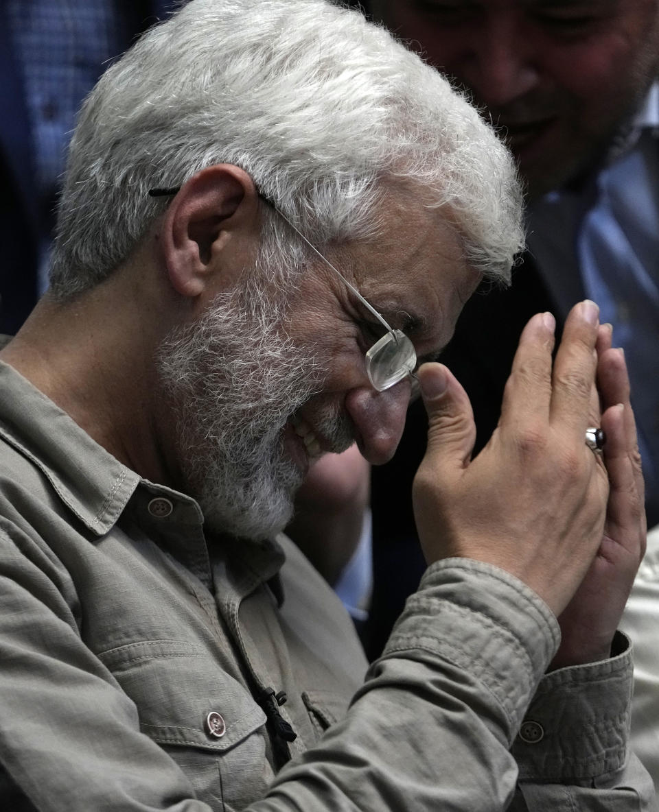 Iranian presidential candidate Saeed Jalili, a hard-line former nuclear negotiator, gestures as he pays his respect to a group of athlete supporters during a campaign stop at a sports hall in Tehran, Iran, Sunday, June 30, 2024. (AP Photo/Vahid Salemi)