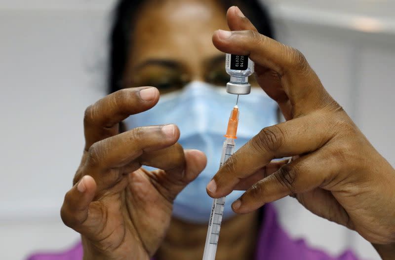 FILE PHOTO: A medical worker prepares a syringe at a coronavirus disease (COVID-19) vaccination center in Singapore