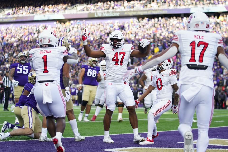 Utah tight end Miki Suguturaga (47) celebrates scoring a touchdown with running back Jaylon Glover (1) and wide receiver Devaughn Vele (17) during the first half of an NCAA college football game against Washington, Saturday, Nov. 11, 2023, in Seattle. | Lindsey Wasson, Associated Press