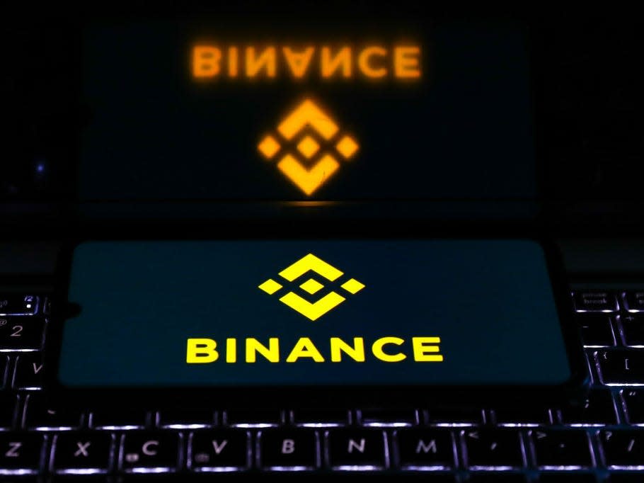 Binance logo is displayed on a mobile phone screen