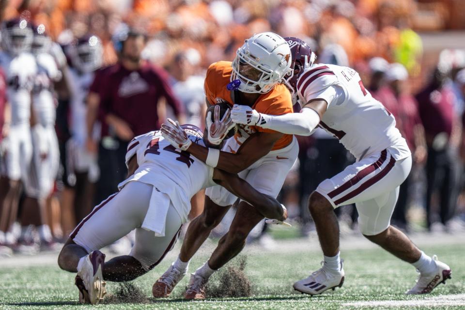 Texas receiver Isaiah Bond fights for yardage in Saturday's game after hauling in a catch from Arch Manning against Mississippi State at Royal-Memorial Stadium in Austin Saturday.