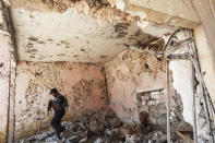 <p>A member of the Iraqi forces patrols inside a damaged building during the advance towards the Old City of Mosul on June 19, 2017 as the ongoing offensive continues to retake the last district still held by the Islamic State (IS) group fighters. (Photo: Ahmad al-Rubaye/AFP/Getty Images) </p>