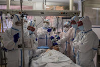 A patient infected with COVID-19 is treated in one of the intensive care units (ICU) at the Severo Ochoa hospital in Leganes, outskirts of Madrid, Spain, Friday, Oct. 9, 2020. (AP Photo/Bernat Armangue)