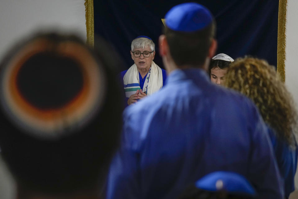 Rabbi Barbara Aiello, left, celebrates the Bat Mitvah ceremony of Mia, 12, in the "Ner Tamid del Sud" (The Eternal Light of the South) synagogue, in Serrastretta, southern Italy, Friday, July 8, 2022. From a rustic, tiny synagogue she fashioned from her family's ancestral home in this mountain village, American rabbi Aiello is keeping a promise made to her Italian-born father: to reconnect people in this southern region of Calabria to their Jewish roots, links nearly severed five centuries ago when the Inquisition forced Jews to convert to Christianity. (AP Photo/Andrew Medichini)