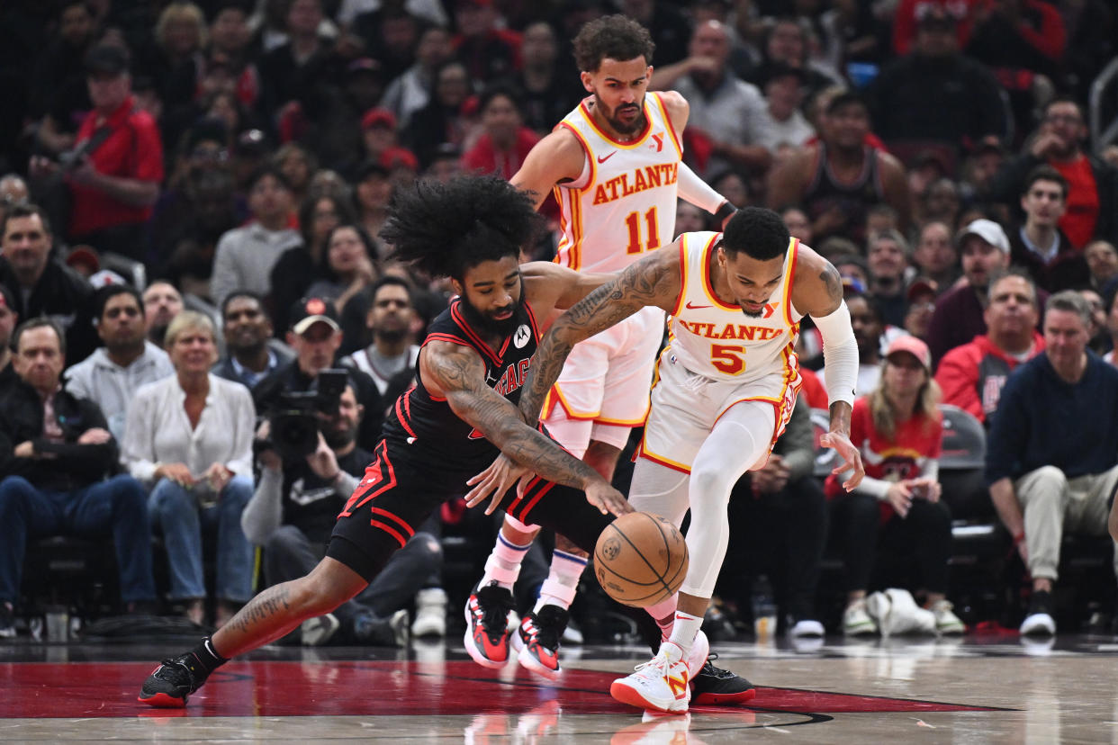 CHICAGO, ILLINOIS - APRIL 17:  Coby White #0 of the Chicago Bulls battles with Dejounte Murray #5 of the Atlanta Hawks for a loose ball in the first half during the play-in tournament on April 17, 2024 at United Center in Chicago, Illinois. NOTE TO USER: User expressly acknowledges and agrees that, by downloading and or using this photograph, User is consenting to the terms and conditions of the Getty Images License Agreement.  (Photo by Jamie Sabau/Getty Images)