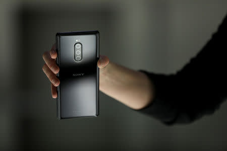 An employee holds a new Sony Xperia X1in this posed photograph at a pre-launch event at the Sony offices in London, Britain February 14, 2019. REUTERS/Simon Dawson/File Photo