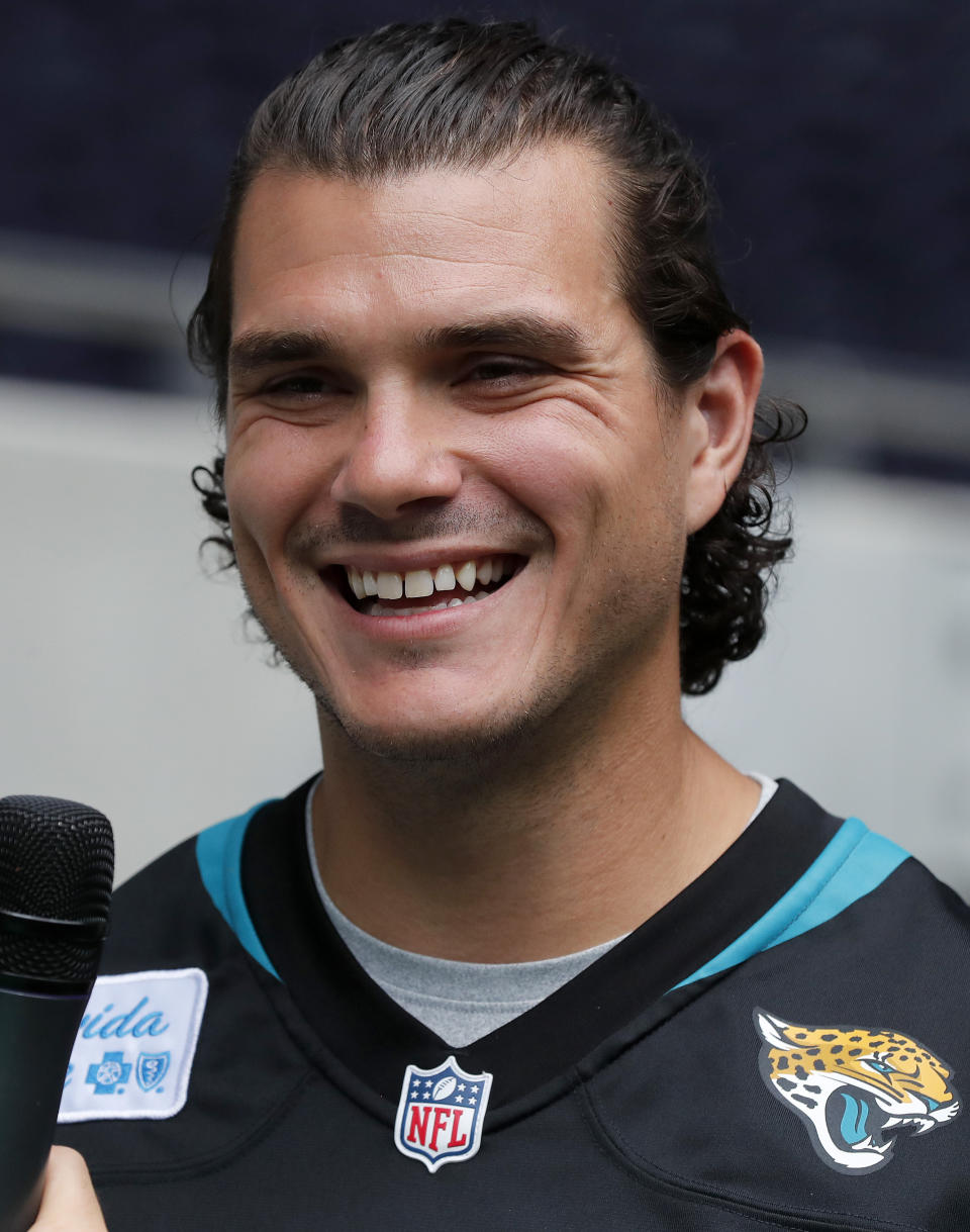 NFL player Josh Lambo of the Jacksonville Jaguars addresses the media during the final tournament for the UK's NFL Flag Championship, featuring qualifying teams from around the country, at the Tottenham Hotspur Stadium in London, Wednesday, July 3, 2019. The new stadium will host its first two NFL London Games later this year when the Chicago Bears face the Oakland Raiders and the Carolina Panthers take on the Tampa Bay Buccaneers. (AP Photo/Frank Augstein)
