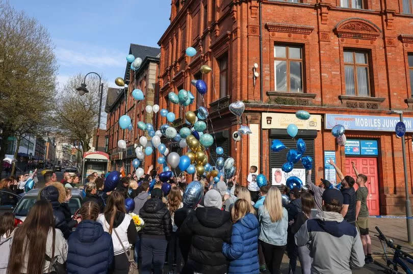 Balloons are released by friends and family of Michael Toohey at the scene of his murder on London Road