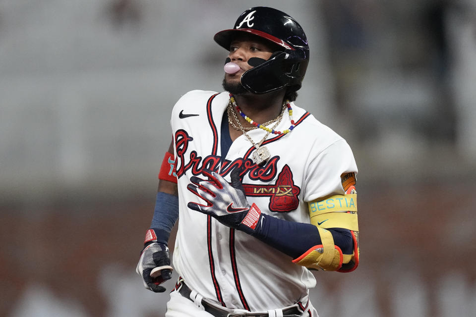 Atlanta Braves' Ronald Acuna Jr. (13) blows a bubble as he runs the bases after hitting a two-run home run in the seventh inning of a baseball game against the Chicago Cubs, Tuesday, Sept. 26, 2023, in Atlanta. (AP Photo/John Bazemore)