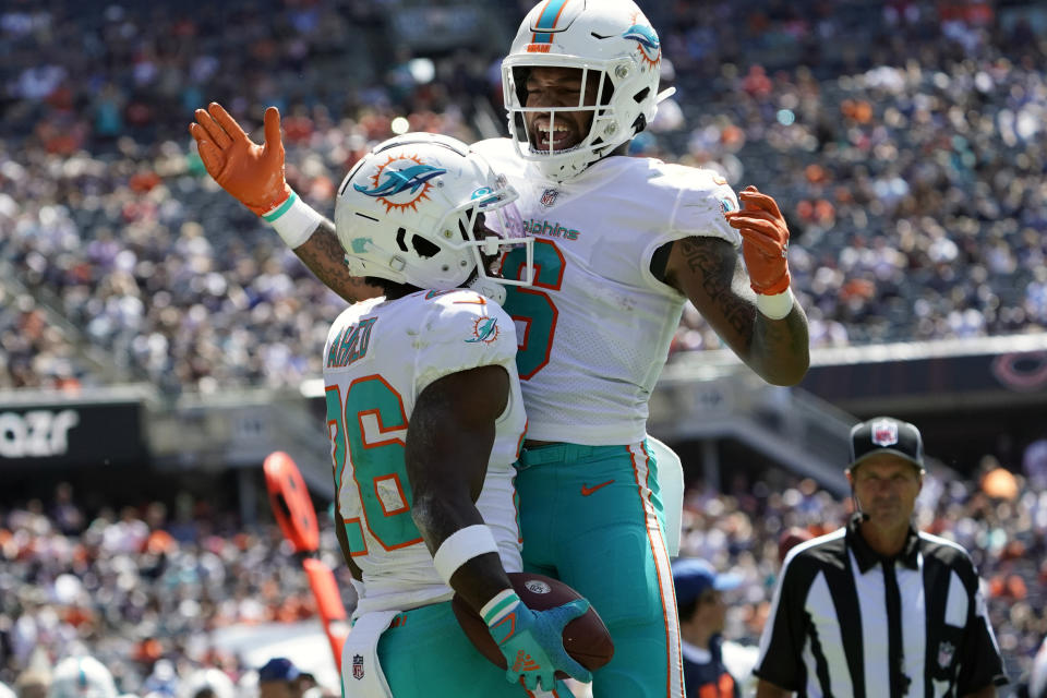 Miami Dolphins running back Salvon Ahmed (26) celebrates his touchdown with Lynn Bowden Jr., right, against the Chicago Bears during the first half of an NFL preseason football game in Chicago, Saturday, Aug. 14, 2021. (AP Photo/David Banks)