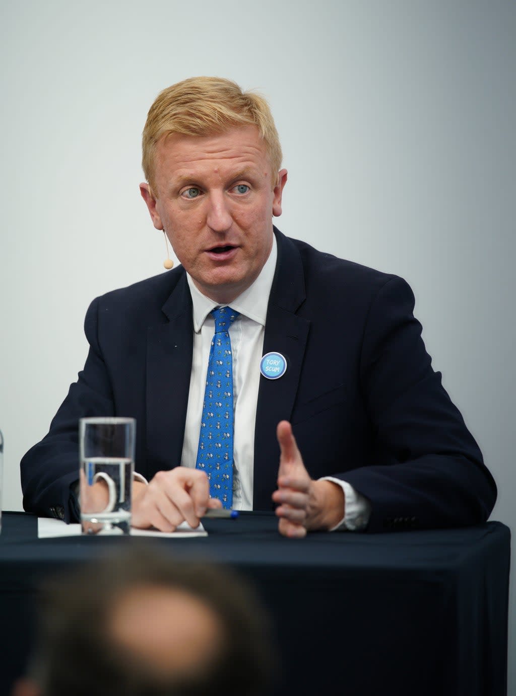 Conservative Party chairman Oliver Dowden wearing a ‘Tory Scum’ badge during the Conservative Party Conference in Manchester (PA) (PA Wire)
