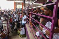 Residents wait at the bus station as they prepare to leave the capital for the remote villages ahead of a contentious election many fear could turn violent, in Abidjan