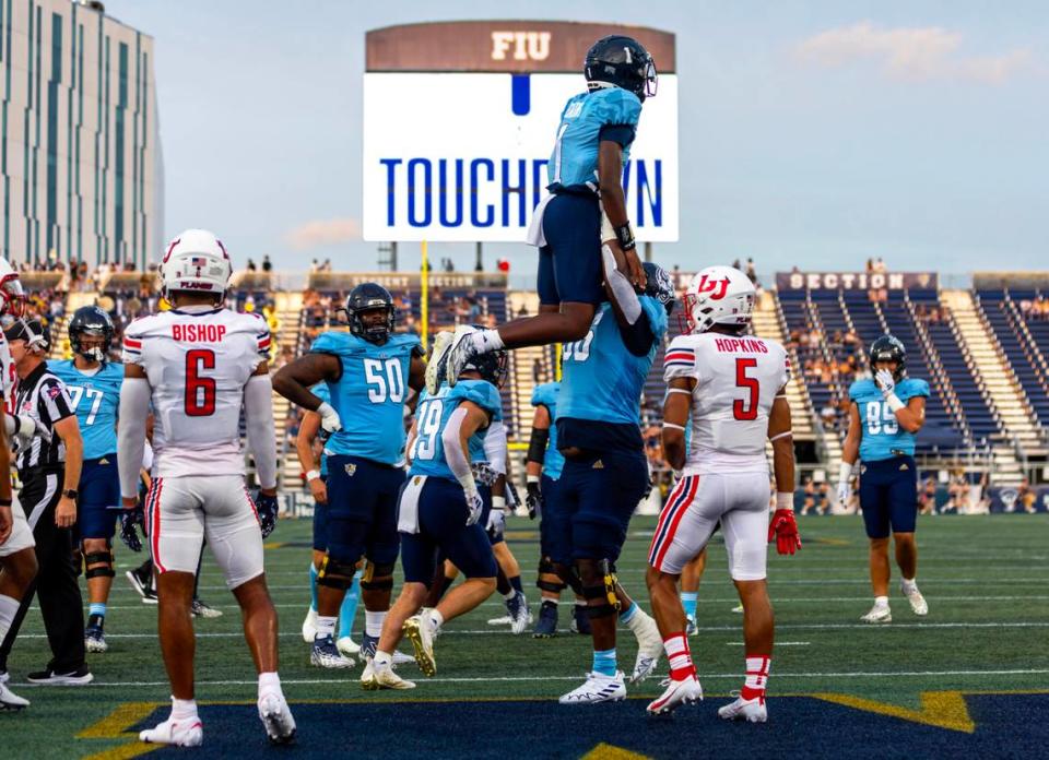 Florida International University quarterback Keyone Jenkins (1) is lifted in the air to celebrate a touchdown during the first half of a college football game against Liberty University at Riccardo Silva Stadium in Miami, Florida, on Saturday, September 23, 2023.