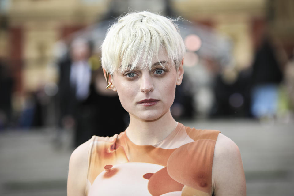 Emma Corrin poses for photographers upon arrival at the Olivier Awards in London, Sunday, April 10, 2022. (Photo by Vianney Le Caer/Invision/AP)