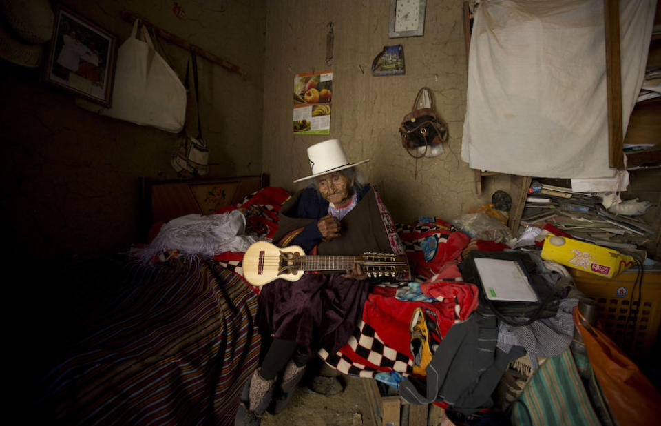 Ms Flores Colque holds a “charango”, a small Andean stringed instrument, at her home in Sacaba, Bolivia (Picture: AP)