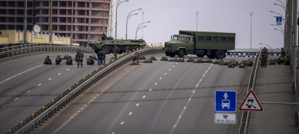 Ukrainian soldiers on a bridge in Kyiv, Ukraine.