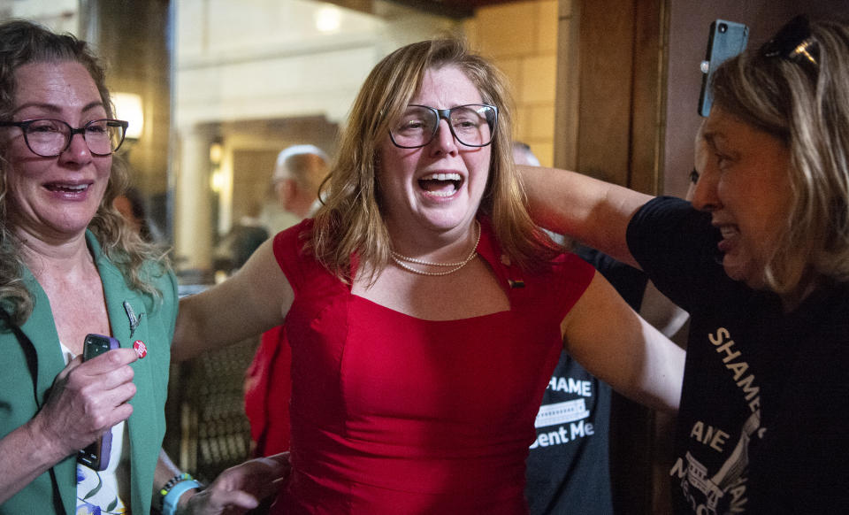 State Sen. Machaela Cavanaugh, center, hugs supporters after a bill seeking to ban abortion in Nebraska after about six weeks fails to advance, Thursday, April 27, 2023, at the Nebraska State Capital in Lincoln, Neb. (Larry Robinson/Lincoln Journal Star via AP)