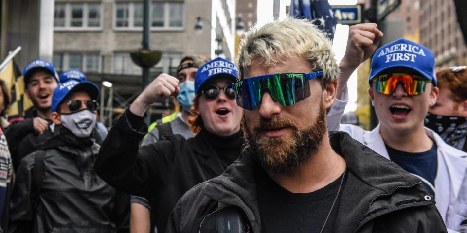 Tim Gionet, better known as Baked Alaska, pictured in sunglasses and cheered on by fellow far right protesters outside Pfizer headquarters on November 13, 2021 in New York City