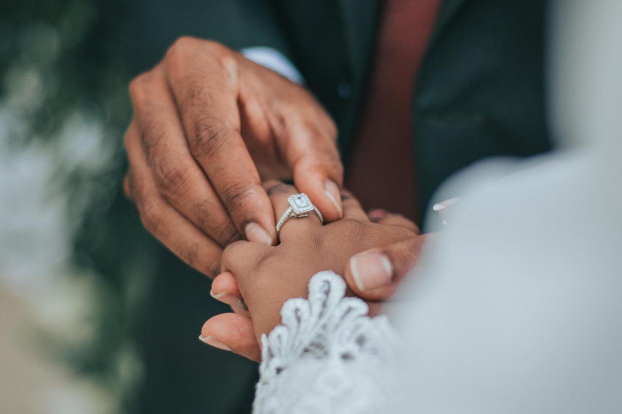 Black couple gets married wedding ring white lace dress