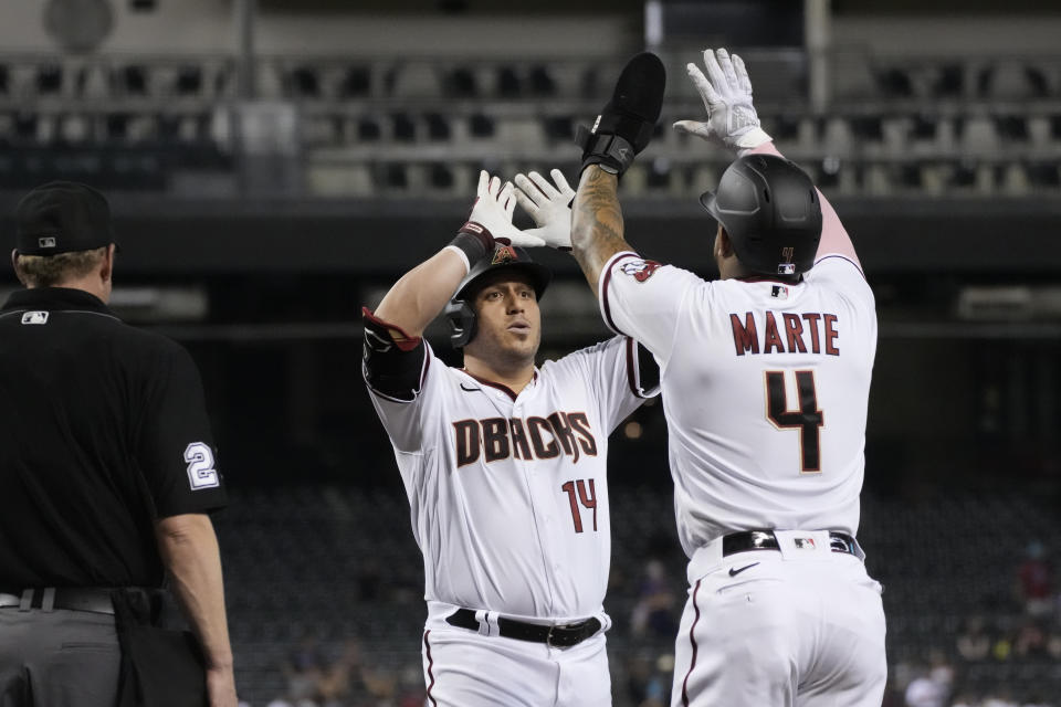 Arizona Diamondbacks' Asdrubal Cabrera celebrates with Ketel Marte (4) after hitting a two-run home run against the San Francisco Giants in the fifth inning during a baseball game, Monday, Aug 2, 2021, in Phoenix. (AP Photo/Rick Scuteri)