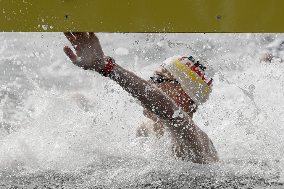 Florian Wellbrock of Germany touches the timing board to win the men's 10km open water swim at the World Swimming Championships in Yeosu, South Korea, Tuesday, July 16, 2019. (AP Photo/Mark Schiefelbein)