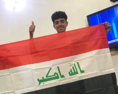 Ahmed Ahmed poses with an Iraq flag in a Facebook photo posted in February 2021.
