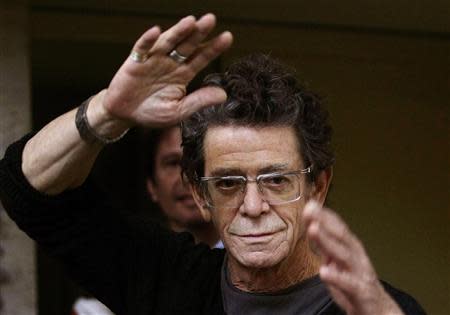 U.S. musician and writer Lou Reed gestures to photographers before his news conference at the International Literature Festival "Kosmopolis 08" in Barcelona, in this October 23, 2008 file photograph. REUTERS/Gustau Nacarino/Files